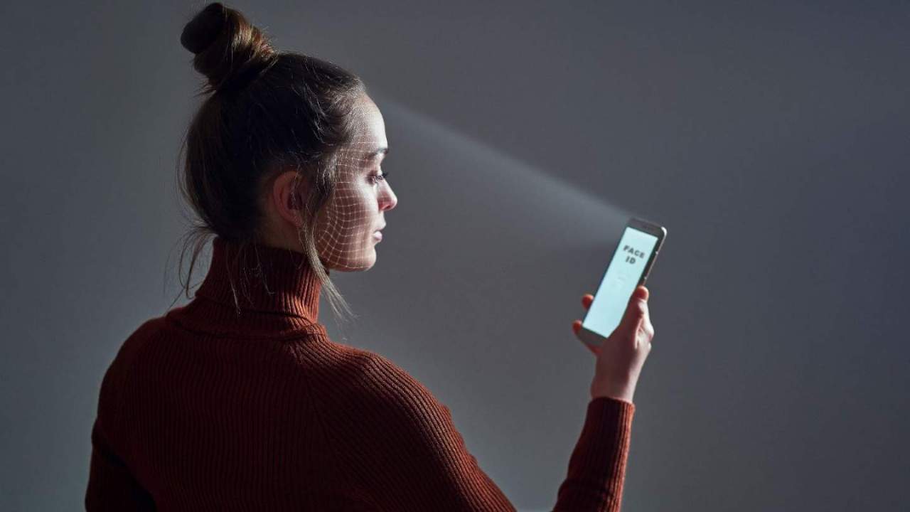 Person scanning face with phone